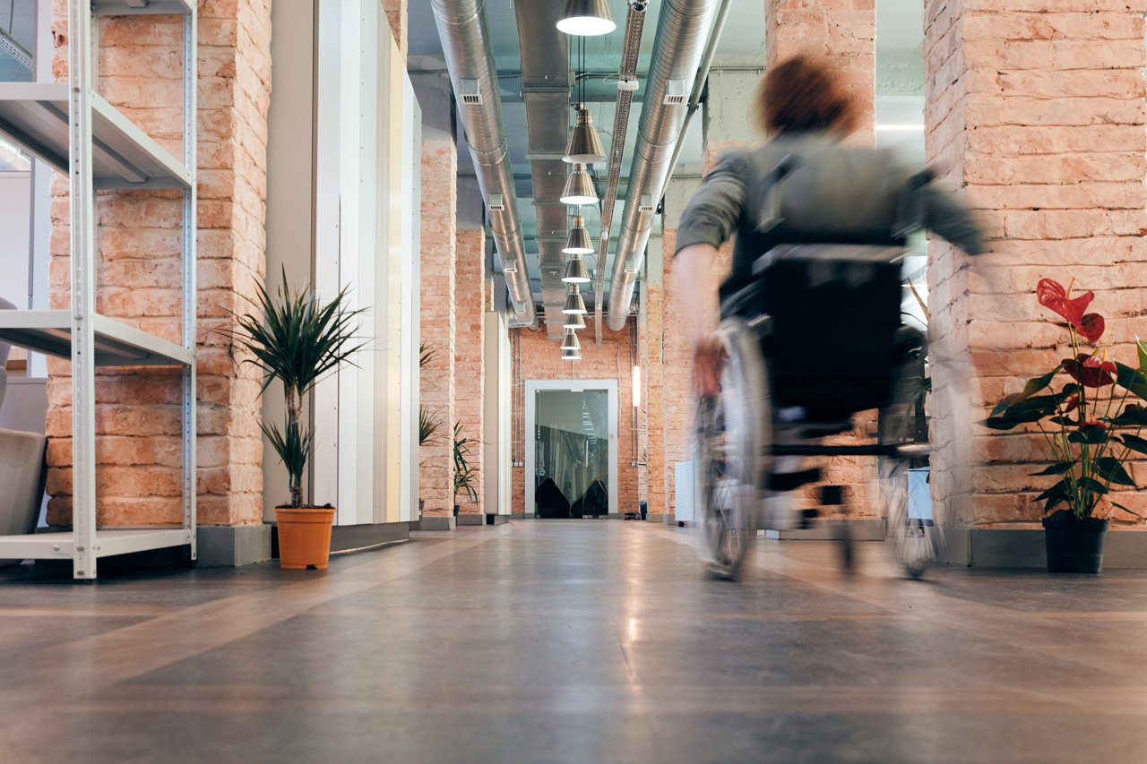 woman using a wheelchair in an office