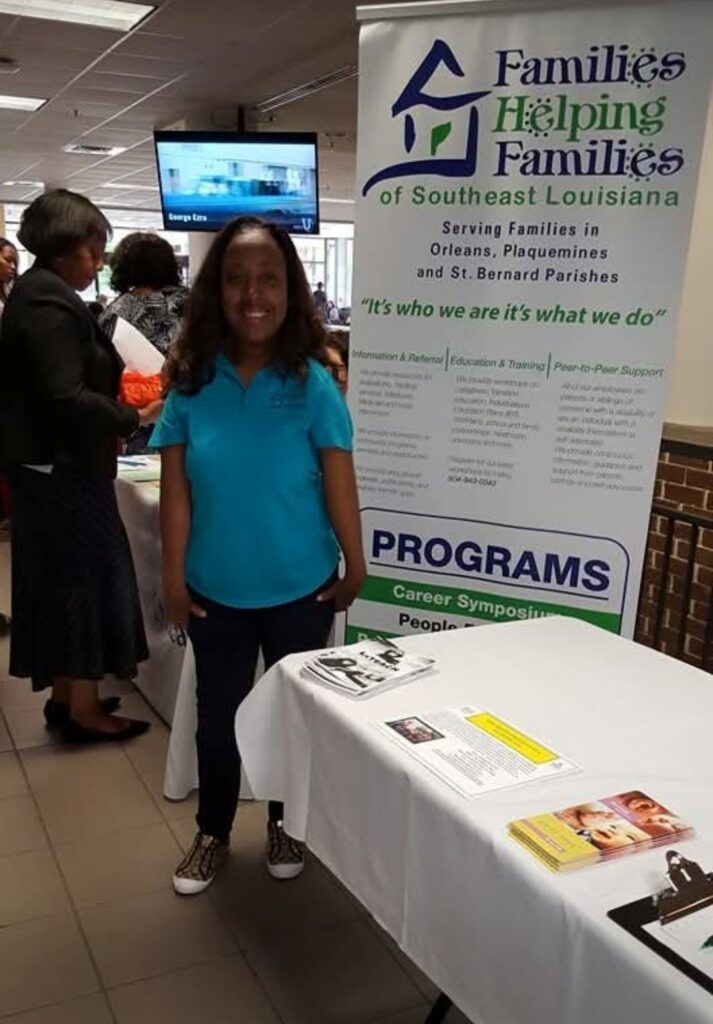 A young woman standing next to a table