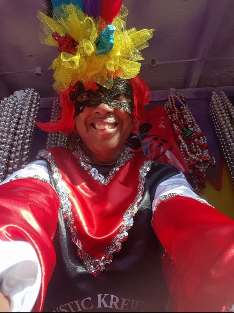 A young woman wearing a Mardi Gras mask