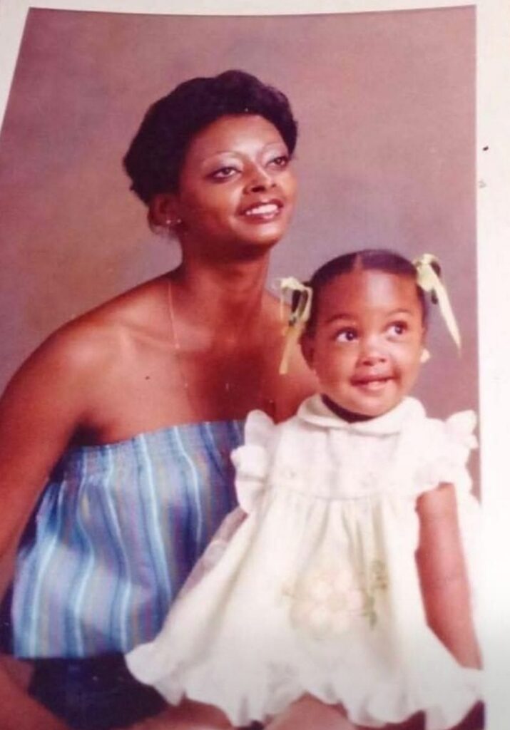 A young girl smiling with her mother